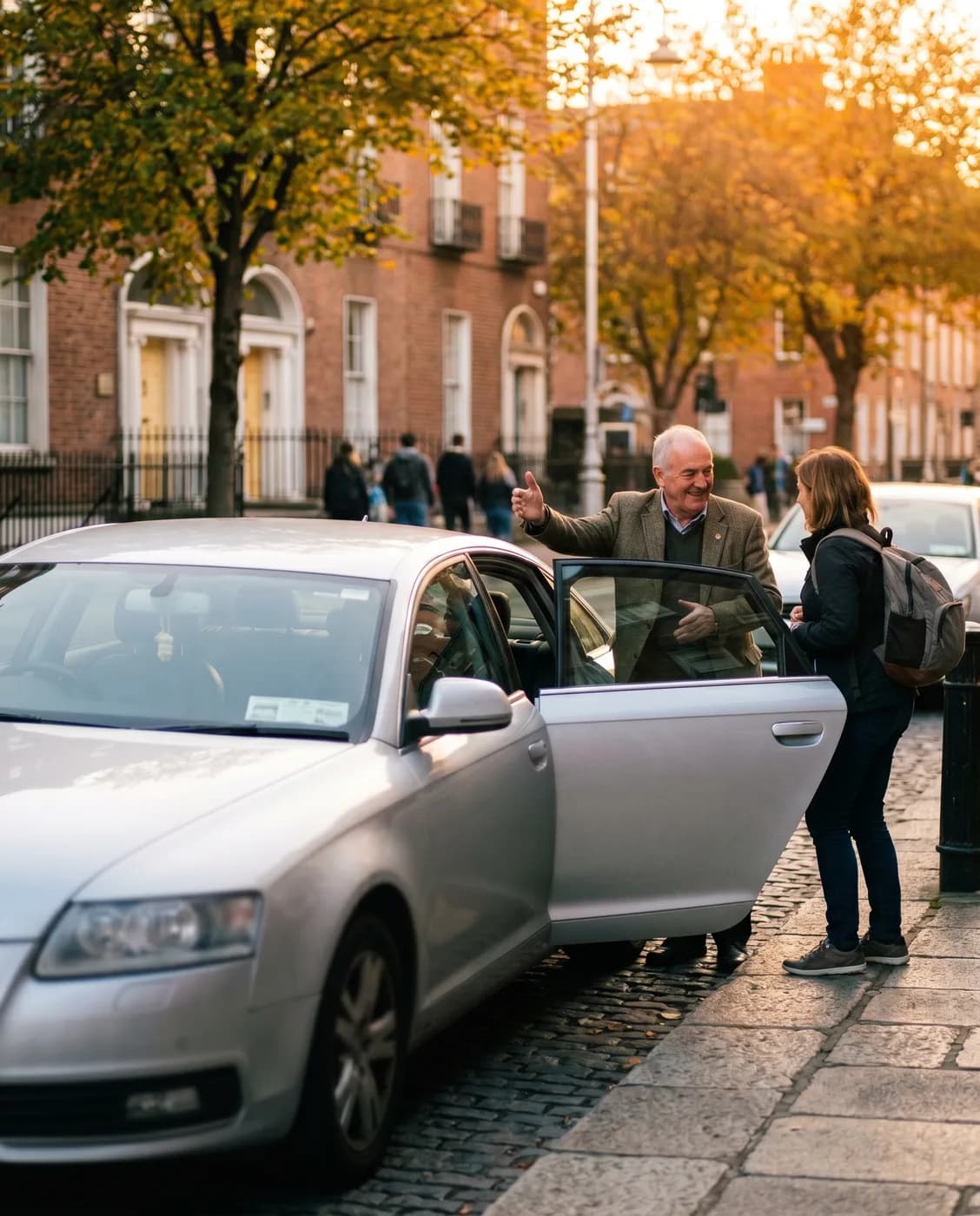 An AJDSL driver greeting a passenger at the kerbside in Dublin at golden hour